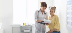 Doctor with young female patient consulting on test results of endosure test